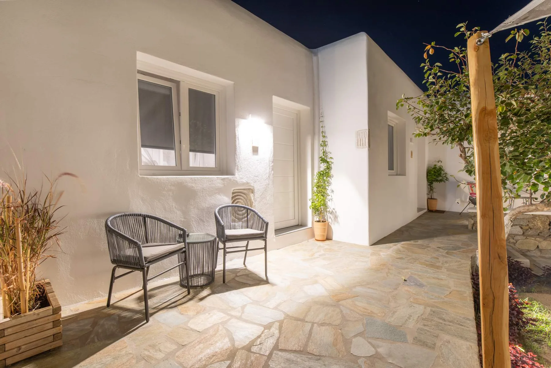 Terrace chairs and stone path at dusk